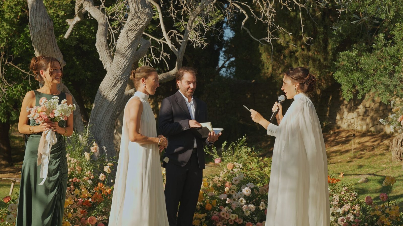 Wedding ceremony among olive trees in the garden of Castello di Vicarello, Tuscany